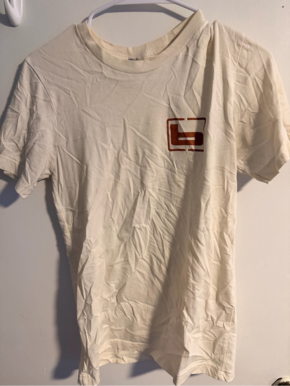 Aknvas Cream Short-Sleeve Tee with Rust Graphic
